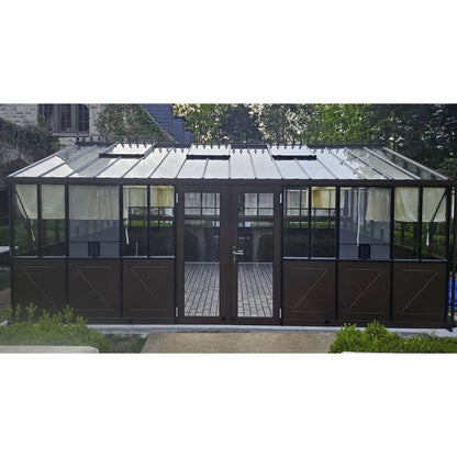 Retro greenhouse with glass panels and metal frame in a garden setting